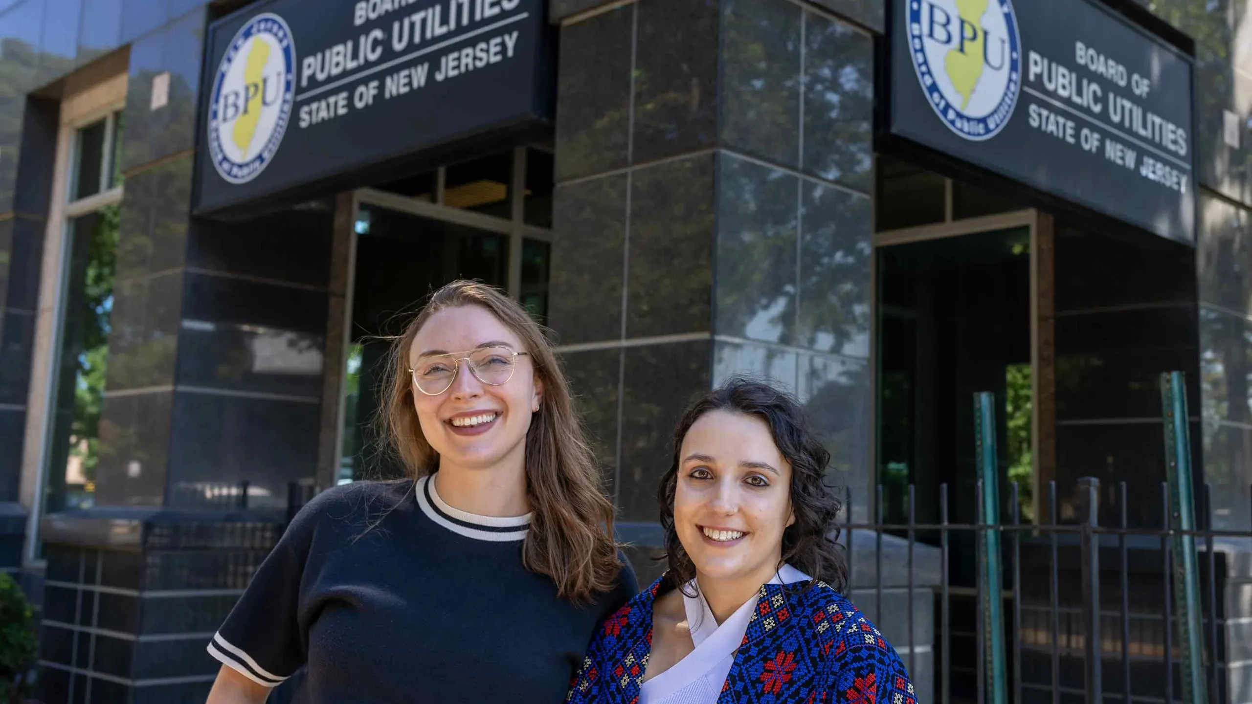 Research scientist Natalie Stuart (left), a 2023-2024 Eagleton Science fellow, stands with Aileen Eagleton, a current Eagleton Science fellow, outside the Board of Public Utilities office in Trenton, N.J. Jeff Arban/Rutgers University